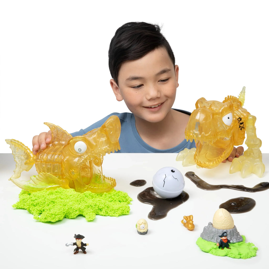 (T-Rex) Slime, and by and Toys, Eggs Skull Dino Age Prehistoric ZURU Toy, 5+ Figurines, More 30 Island Discovery Over Giant Mini Dinosaur Smashers Sand Surprises, with